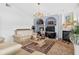 Living room featuring a fireplace, built-in shelving and tiled floors at 2076 Shannon Lakes Blvd, Kissimmee, FL 34743