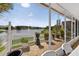 Relaxing screened patio overlooking the lake with comfortable seating area and potted plants at 2076 Shannon Lakes Blvd, Kissimmee, FL 34743