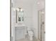 Modern bathroom with tiled shower, gray vanity, and ample lighting at 2290 Brix Sts, Orlando, FL 32804