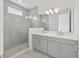 Elegant bathroom featuring a glass-enclosed shower and double sink vanity at 2290 Brix Sts, Orlando, FL 32804