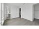 Bright bedroom with wood-look floors and doors to the bathroom and hallway at 2290 Brix Sts, Orlando, FL 32804