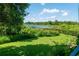 The backyard has a peaceful view of a lake and mature trees at 2673 Rutledge Ct, Winter Haven, FL 33884