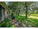 Backyard featuring a pond, lush green grass, and large shade trees at 2673 Rutledge Ct, Winter Haven, FL 33884