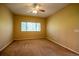 Cozy bedroom with carpet flooring, a ceiling fan, and natural light, providing a tranquil retreat for rest and relaxation at 2673 Rutledge Ct, Winter Haven, FL 33884