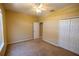Spacious bedroom with carpet flooring, ceiling fan, closet, and neutral paint, providing comfort and versatility at 2673 Rutledge Ct, Winter Haven, FL 33884