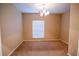 Neutral dining room featuring a chandelier, window with blinds, and carpeted floor at 2673 Rutledge Ct, Winter Haven, FL 33884