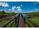 Picturesque dock on a calm lake featuring lush greenery, perfect for enjoying scenic views at 2673 Rutledge Ct, Winter Haven, FL 33884