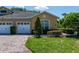 Charming townhome featuring a well-kept lawn, landscaping, brick paved driveway and two-car garage at 2673 Rutledge Ct, Winter Haven, FL 33884