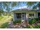 Exterior view of the home and screened in porch overlooking the yard and landscaping at 2673 Rutledge Ct, Winter Haven, FL 33884