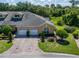 Beautiful two-story townhome with well-manicured lawn, shrubbery and brick paved driveway at 2673 Rutledge Ct, Winter Haven, FL 33884