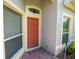 Inviting front door with transom window, flanked by sidelights and a brick paved entrance at 2673 Rutledge Ct, Winter Haven, FL 33884