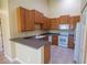 Functional kitchen featuring wood cabinets, ample countertop space, and essential appliances, offering practicality and efficiency at 2673 Rutledge Ct, Winter Haven, FL 33884