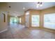 Spacious living room featuring tile floors, neutral paint, and glass sliding doors leading to lanai at 2673 Rutledge Ct, Winter Haven, FL 33884