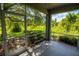 A screened-in patio has an outdoor view of lush greenery and trees at 2673 Rutledge Ct, Winter Haven, FL 33884