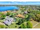 Expansive lakefront property showcasing a luxurious home with a private pool surrounded by lush greenery at 3130 Butler Bay N Dr, Windermere, FL 34786