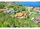 Beautiful waterfront home featuring a backyard pool, perfectly set amid lush greenery and mature trees at 3130 Butler Bay N Dr, Windermere, FL 34786
