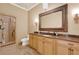 Well-appointed bathroom with a glass shower, granite countertops, and a large mirror at 3130 Butler Bay N Dr, Windermere, FL 34786