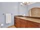 Bathroom featuring granite countertops, wooden cabinets, and a beautifully tiled shower area at 3130 Butler Bay N Dr, Windermere, FL 34786