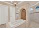 Elegant bathroom featuring a soaking tub and walk-in shower with designer tile surround at 3130 Butler Bay N Dr, Windermere, FL 34786