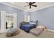 Bright bedroom features a ceiling fan, a window, and a cozy nook, perfect for relaxing or reading at 3130 Butler Bay N Dr, Windermere, FL 34786