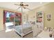 Bedroom featuring a four-poster bed, chandelier, desk and large window overlooking the pool at 3130 Butler Bay N Dr, Windermere, FL 34786