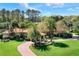 Beautiful home featuring a terracotta roof, arched windows, mature trees, lush landscaping and brick driveway at 3130 Butler Bay N Dr, Windermere, FL 34786