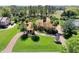 Beautifully landscaped home featuring a circular driveway, mature palm trees, and a meticulously manicured lawn at 3130 Butler Bay N Dr, Windermere, FL 34786