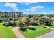 Beautiful home featuring a terracotta roof, mature trees, lush landscaping and brick driveway at 3130 Butler Bay N Dr, Windermere, FL 34786