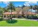 Stunning single-story home featuring a terracotta roof, lush landscaping, and a circular driveway at 3130 Butler Bay N Dr, Windermere, FL 34786