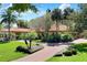 Stunning single-story home featuring a terracotta roof, lush landscaping, and a brick driveway at 3130 Butler Bay N Dr, Windermere, FL 34786