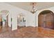 Open foyer with elegant archways, chandelier, fireplace and terra cotta flooring at 3130 Butler Bay N Dr, Windermere, FL 34786