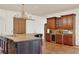 Beautiful kitchen featuring an island with seating, custom cabinets, and tile floors at 3130 Butler Bay N Dr, Windermere, FL 34786
