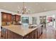 Gourmet kitchen featuring a large island with granite countertops and custom cabinetry at 3130 Butler Bay N Dr, Windermere, FL 34786