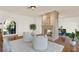 Bright living room featuring a stone fireplace, hardwood floors and white accent chairs at 3130 Butler Bay N Dr, Windermere, FL 34786