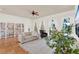 Cozy living room featuring bright natural light, tile flooring, and a bookshelf at 3130 Butler Bay N Dr, Windermere, FL 34786