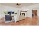 Bright living room with white walls, terracotta tile flooring, and a cozy fireplace at 3130 Butler Bay N Dr, Windermere, FL 34786