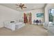 Main bedroom with a ceiling fan, en-suite bathroom, and outdoor access at 3130 Butler Bay N Dr, Windermere, FL 34786