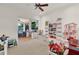 Bright playroom with sliding doors to outdoor kitchen, filled with toys and games at 3130 Butler Bay N Dr, Windermere, FL 34786