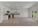 Well-lit kitchen with granite countertops, stainless steel appliances and access to the backyard at 3398 Vesara Dr, Davenport, FL 33837