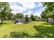 The large backyard features a patio and plenty of green space for activities at 3515 Leslie Dr, Orlando, FL 32806