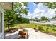 Relaxing backyard patio area surrounded by mature trees and lush landscaping at 3515 Leslie Dr, Orlando, FL 32806