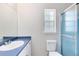 Cozy bathroom with blue countertop, toilet and walk-in shower with blue trim and hardware at 3515 Leslie Dr, Orlando, FL 32806