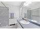 Bathroom featuring a large mirror, vanity with grey countertop and a shower with unique tile accents at 3515 Leslie Dr, Orlando, FL 32806