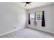 Bright bedroom with neutral walls, ceiling fan and carpet and a large window for natural light at 3515 Leslie Dr, Orlando, FL 32806
