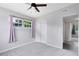 Bright bedroom with a window, ceiling fan, and double door closet at 3515 Leslie Dr, Orlando, FL 32806