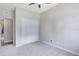 A cozy bedroom featuring a ceiling fan, neutral carpet, closet and a doorway to another room at 3515 Leslie Dr, Orlando, FL 32806