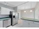 Updated kitchen with stainless steel appliances and a breakfast bar at 3515 Leslie Dr, Orlando, FL 32806
