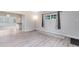 Sunlit living area showcasing sleek laminate flooring and neutral decor at 3515 Leslie Dr, Orlando, FL 32806