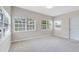 Open living room with carpeted floors and natural light from the large windows at 3515 Leslie Dr, Orlando, FL 32806
