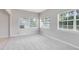 Large windows illuminate the carpeted floors of this airy living room at 3515 Leslie Dr, Orlando, FL 32806